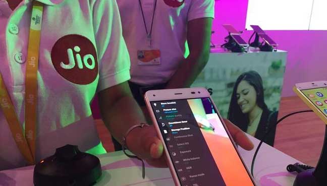 Jio representative showcasing smartphone connectivity at a demo counter