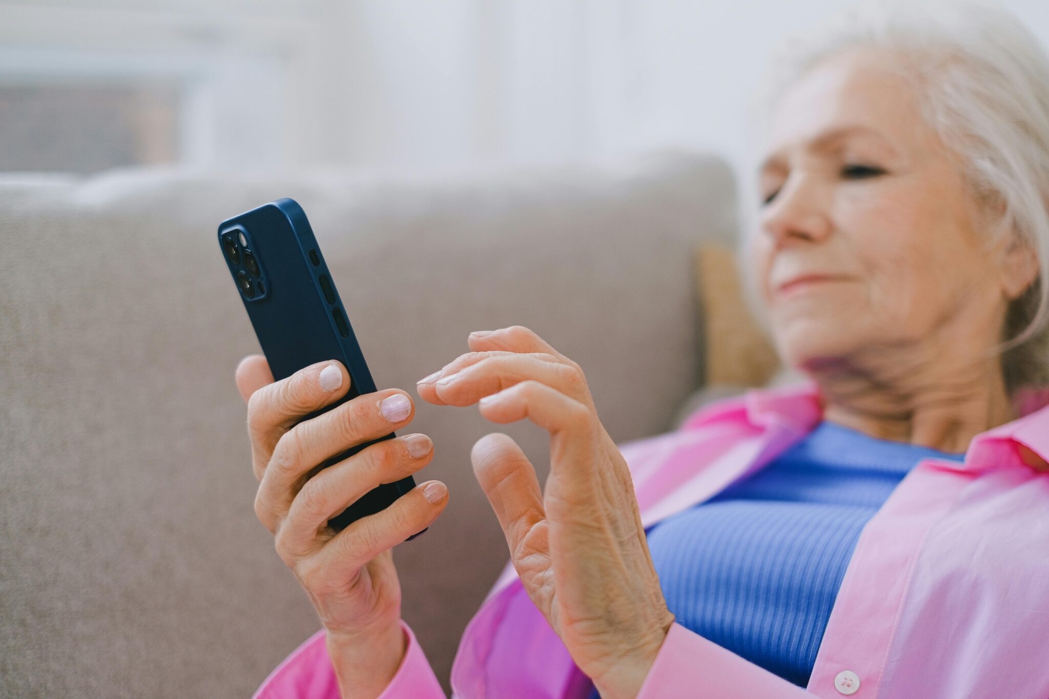 A lady is trying to get mobile signal at home