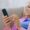 A lady is trying to get mobile signal at home