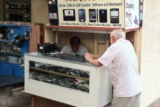 Mobile phone kiosk on a street in Mumbai